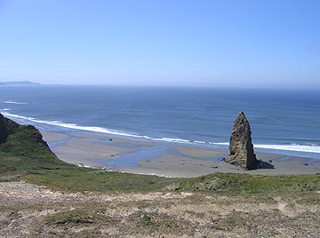 One needle of rock on a sandy beach