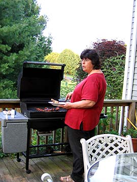Kathy barbecuing steaks