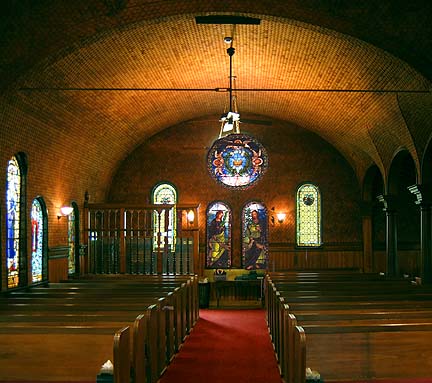 The rear wall of the church, entry doors to the left